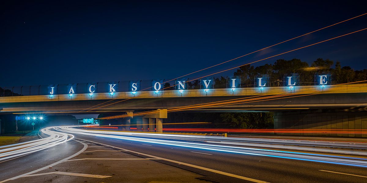 NIghttime drive on the highway with the overpass sign of Jacksonville.